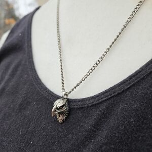 silver tone chain with eagle head pendant